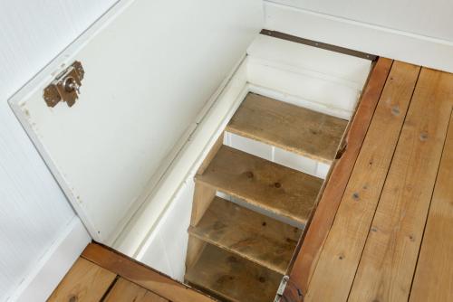 an attic room with a door and a shelf at Chesa-strimer - Rustica in La Punt-Chamues-ch