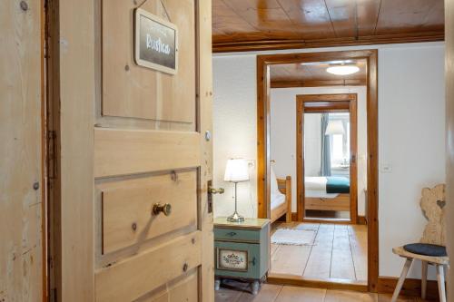 a room with a door and a bedroom with a bed at Chesa-strimer - Rustica in La Punt-Chamues-ch