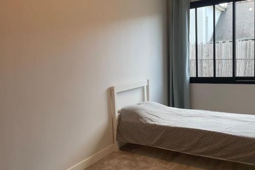 a small bedroom with a bed and a window at Le Loft des Lumières in Château-Gontier