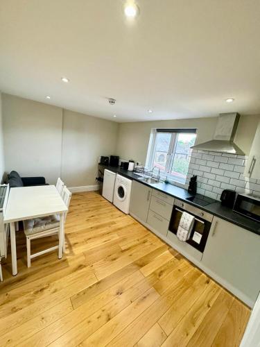 a kitchen with a table and a dining room at Lovely flat in Brockley, SE4 in London