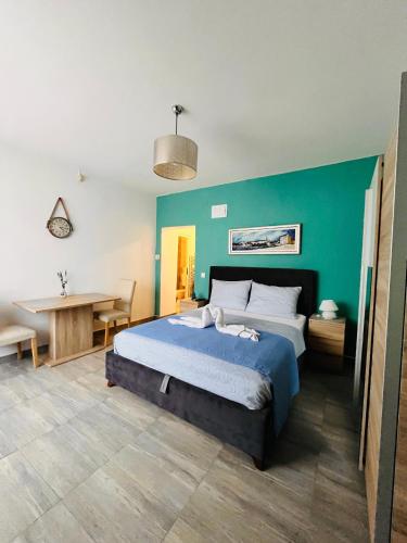 a bedroom with a bed with a blue wall at Apartments Kristal in Kaštela