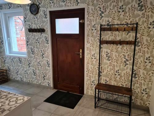 a room with a door and a chair and a window at au carnassier du der in Arrigny
