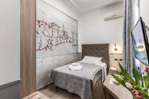 a small room with a bed and a table at Hotel Centro Cavour Roma in Rome