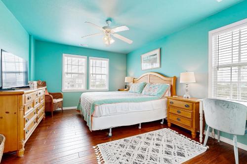 a bedroom with a bed and a ceiling fan at 3 Little Birds #14-H in Hatteras