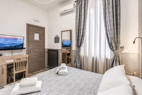 a hotel room with a bed and a television at Hotel Centro Cavour Roma in Rome