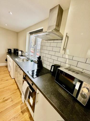 a kitchen with a sink and a counter top at Lovely flat in Brockley, SE4 in London