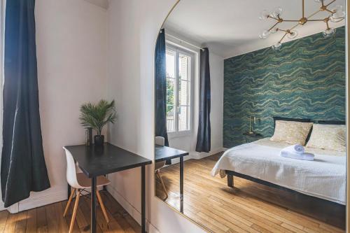 a bedroom with a bed and a desk and a window at Centre - Parking - Cathédrale in Reims