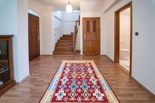 a hallway with a rug on the floor in a house at Villa Deniz in Fethiye