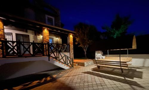 a bench in front of a house at night at Villa Deniz in Fethiye