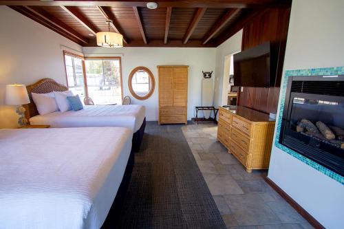 a hotel room with two beds and a flat screen tv at Edgewater Beach Inn in Santa Cruz