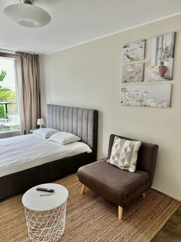 a bedroom with a bed and a chair at Aisa 39 in Pärnu