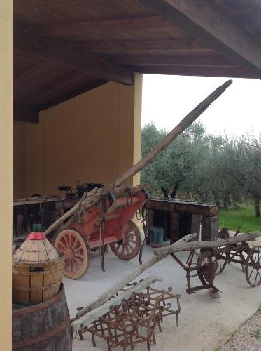 a red horse drawn carriage sitting next to a building at Agriturismo Il Truffarello TODI in Todi