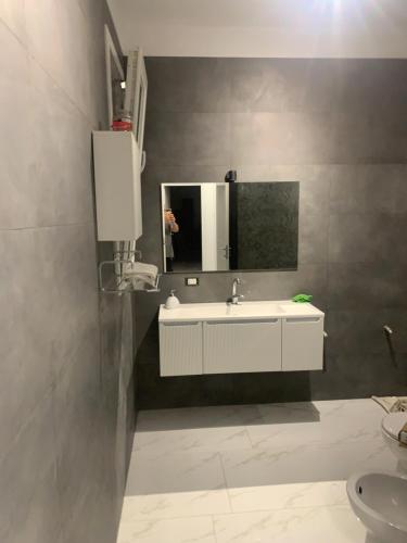 a bathroom with a sink and a mirror at B&B Passione Salento in Surbo