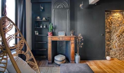 a living room with a table and a fireplace at «Coeur de vie » logement hyper centre de Bagnères de Bigorre in Bagnères-de-Bigorre