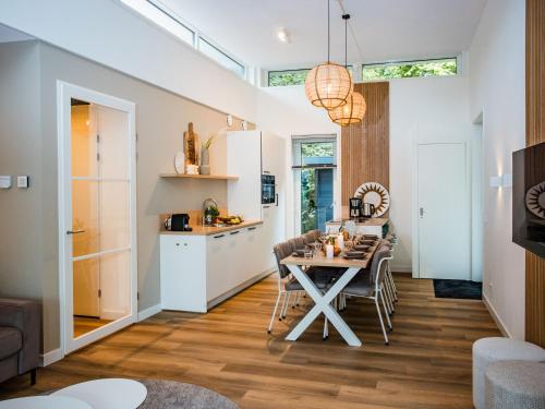 a kitchen and dining room with a table and chairs at Holiday Home in Voorthuizen near Forest in Voorthuizen