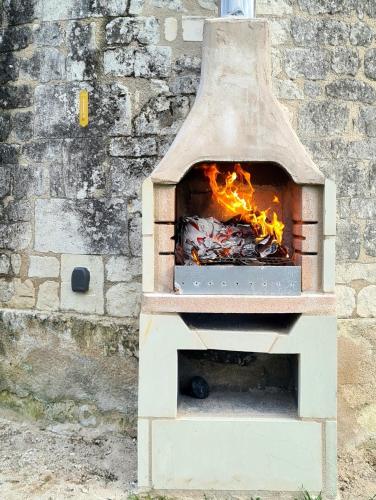 a brick oven with a fire inside of it at Moulin à vent romantique et atypique en Touraine in Seuilly