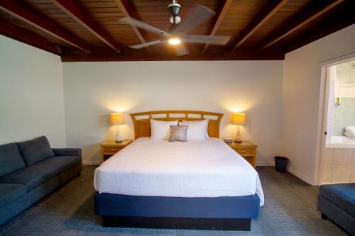a bedroom with a bed and a chair and a couch at Edgewater Beach Inn in Santa Cruz