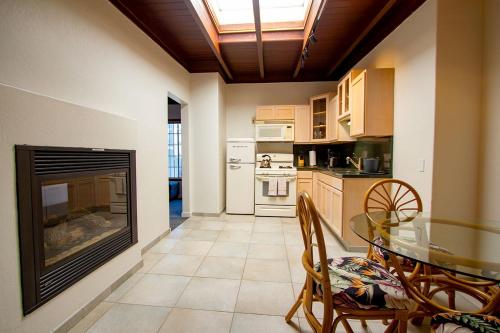 a kitchen with a fireplace and a table and chairs at Edgewater Beach Inn in Santa Cruz