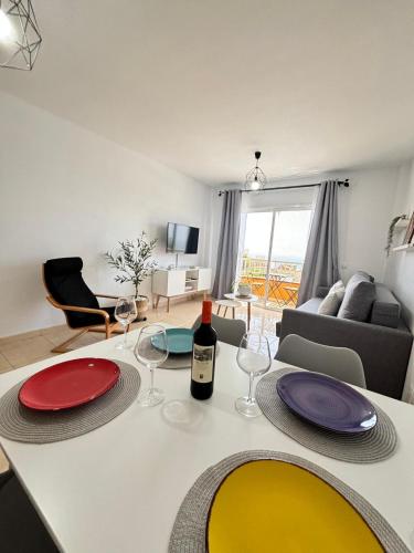a living room with a table with a bottle of wine at Vista Montemar in San Miguel de Abona
