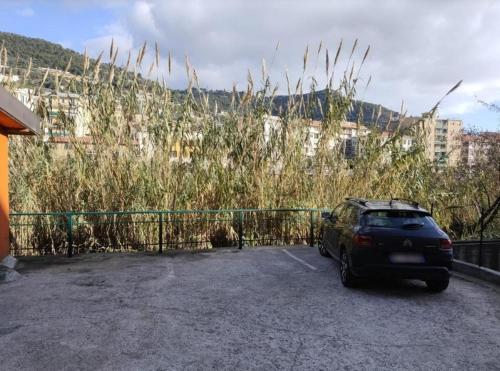 a car parked in a parking lot next to a fence at Discesa Marina in Ventimiglia