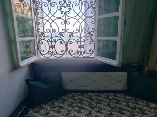 a bedroom with a window and a bed in front of it at studio confortable in Tabarka