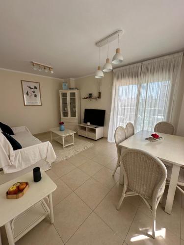 a living room with a table and a couch at Century in Calpe