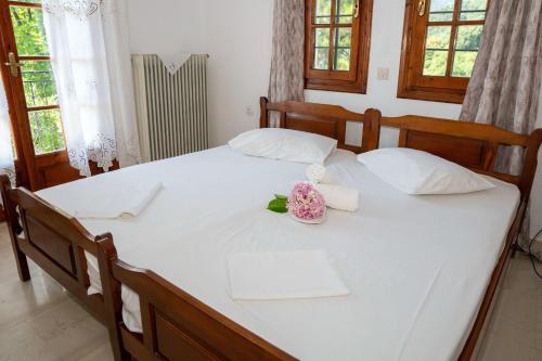 a large white bed with white sheets and white pillows at Paradeisos Rooms Pelion in Agios Dimitrios