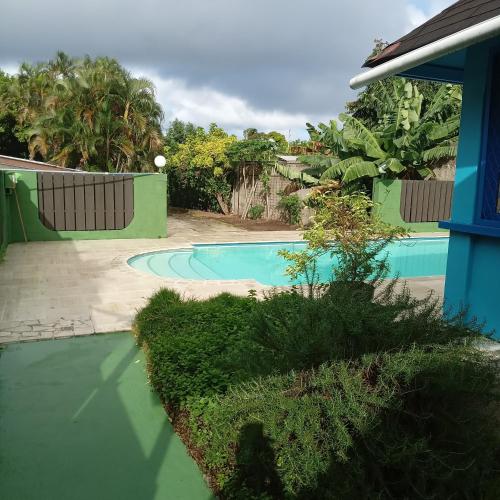 une piscine dans une cour clôturée dans l'établissement Fare MIHIMANA, à Paea