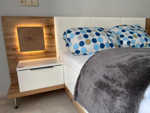 a bedroom with a bed with a nightstand next to it at Horský apartmán Nový Javor - s možností využití wellness in Železná Ruda