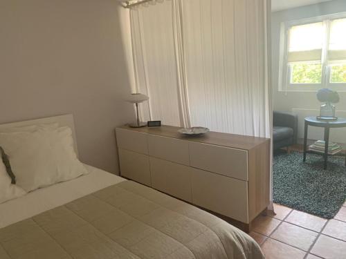 une chambre avec un lit, une commode et une fenêtre dans l'établissement Magnifique T1 entre mer et montagne, à Ascain