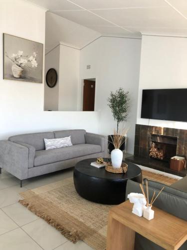 a living room with a couch and a table at Bluebanana Lodge in Mthatha