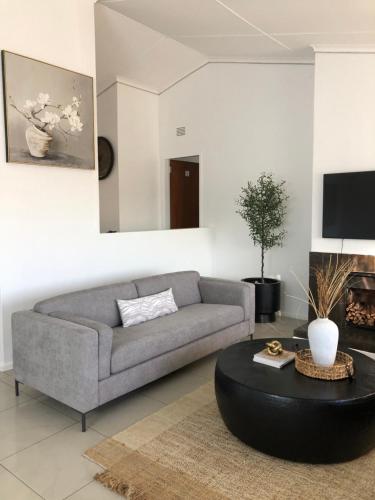 a living room with a couch and a coffee table at Bluebanana Lodge in Mthatha