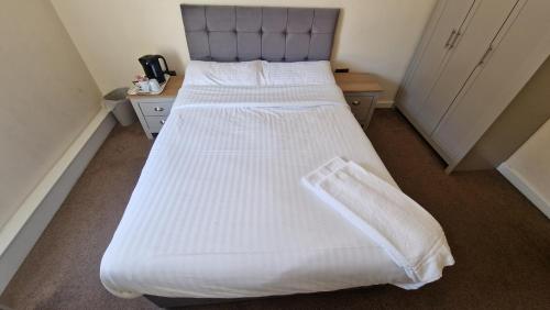 a bedroom with a large bed with white sheets at APARTMENT in CENTRAL HALIFAX in Halifax