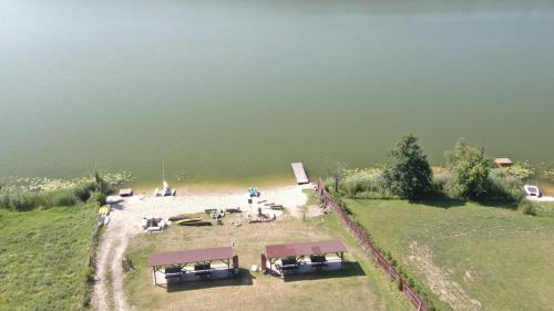 an aerial view of a beach next to a body of water at Nad Sunowem Lake House in Chrzanowo