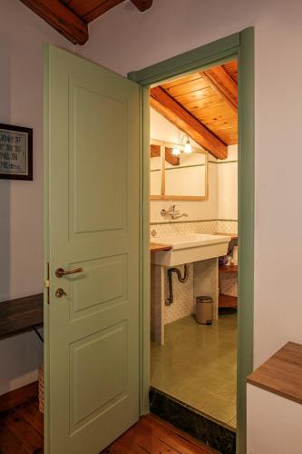 a door leading into a bathroom with a sink at La campagna e il mare in Catania