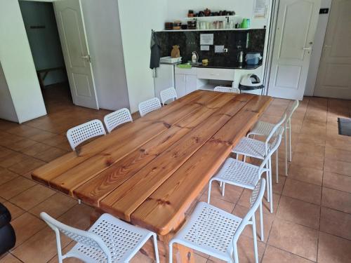 a large wooden table and chairs in a kitchen at Toma pirts LIELĀ in Ikšķile
