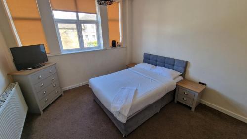 a small bedroom with a bed and a television at APARTMENT in CENTRAL HALIFAX in Halifax