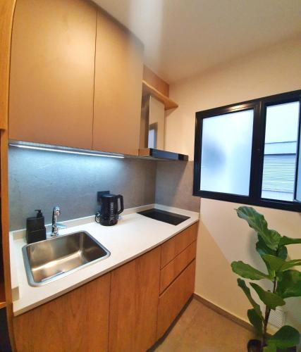 a small kitchen with a sink and a window at Oh Barrancas in Buenos Aires