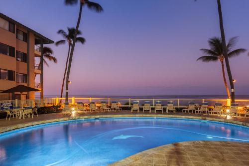 a swimming pool with a view of the ocean at Castle At Kona Reef in Kailua-Kona