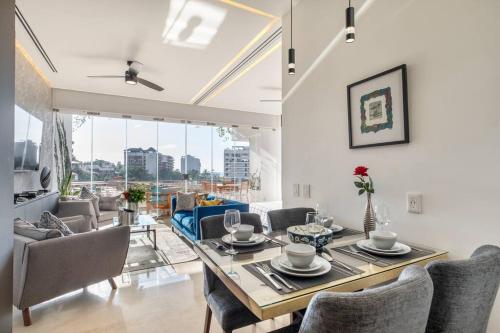 a dining room with a table and chairs at New! Luxury 2bd 2ba Romantic Zone Largest Pool in PV Sea View Balcony in Puerto Vallarta