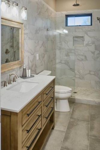 a bathroom with a sink and a toilet and a shower at Serenity Barn in Mooresville