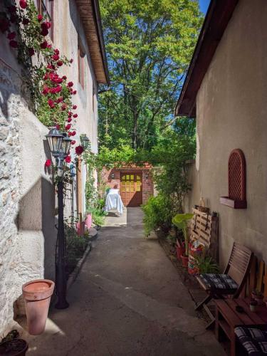 an alley with a gate and some plants and flowers at ABAGuesthouse in Sarajevo