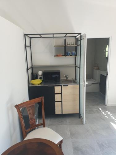 a kitchen with a counter and a sink and a chair at Quinta de São Pedro in Sobreda