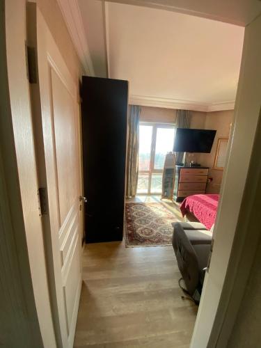 a room with a door leading to a bedroom with a bed at Private villa suitable for families with stunning sea views in Buyukcekmece