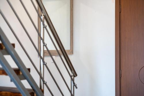 a stairwell with a ladder and a mirror at Majestic house in Neos Marmaras