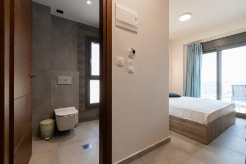 a bedroom with a bed and a bathroom with a shower at Majestic house in Neos Marmaras
