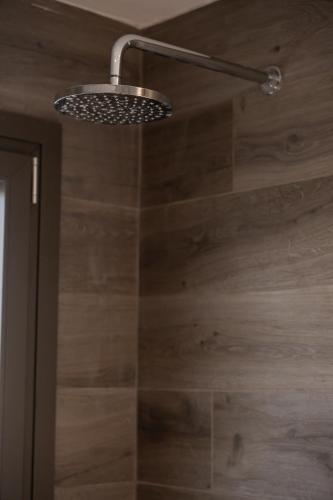 a shower with a shower head in a bathroom at Majestic house in Neos Marmaras