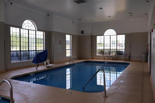 a large swimming pool in a building with windows at Namaste Inn & Suites Dawsonville in Dawsonville