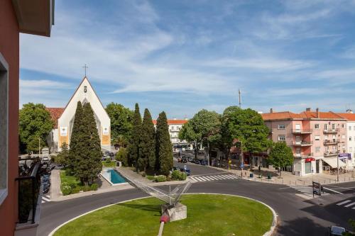 a church with a park in the middle of a street at Varanda dos Poetas in Lisbon