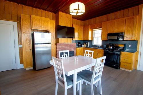 a kitchen with a table and chairs and a refrigerator at Edgewater Beach Inn in Santa Cruz